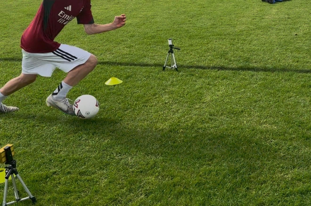 Dribble analysis filming setup, ball-level 240fps camera capturing contact mechanics